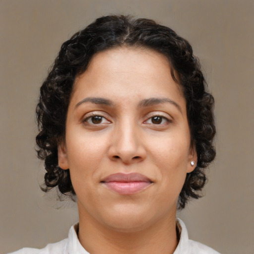 Joyful latino young-adult female with medium  brown hair and brown eyes