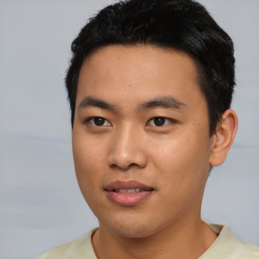 Joyful asian young-adult male with short  black hair and brown eyes