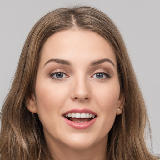 Joyful white young-adult female with long  brown hair and grey eyes