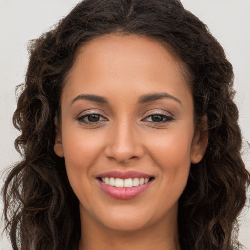 Joyful white young-adult female with long  brown hair and brown eyes