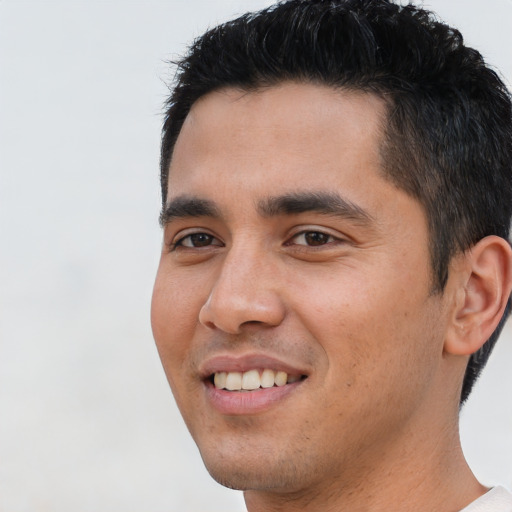 Joyful asian young-adult male with short  brown hair and brown eyes
