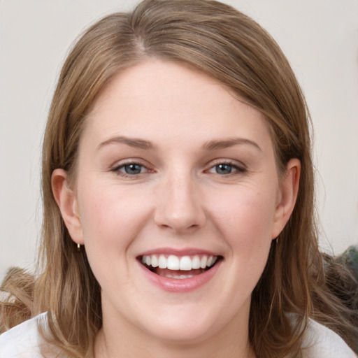 Joyful white young-adult female with medium  brown hair and grey eyes