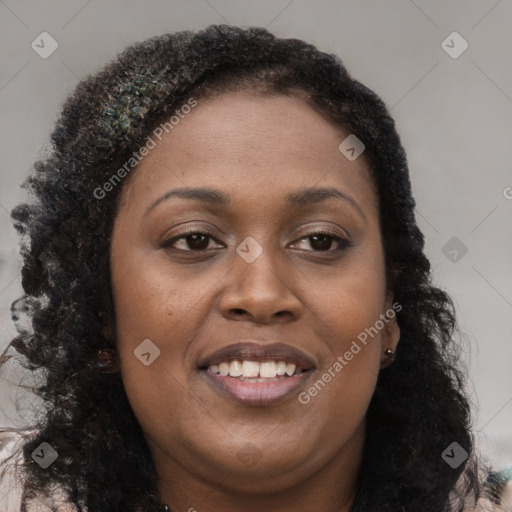 Joyful black young-adult female with long  brown hair and brown eyes