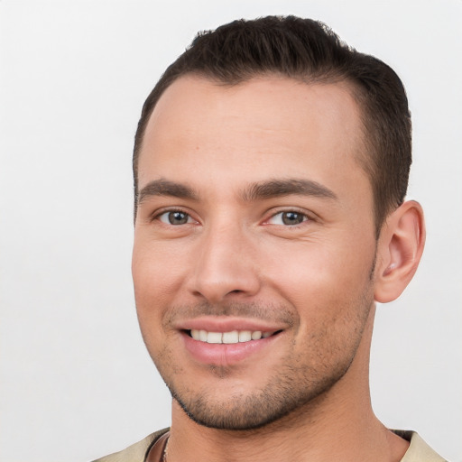 Joyful white young-adult male with short  brown hair and brown eyes