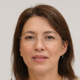 Joyful white adult female with medium  brown hair and grey eyes