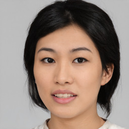 Joyful asian young-adult female with medium  black hair and brown eyes