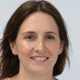 Joyful white adult female with medium  brown hair and brown eyes