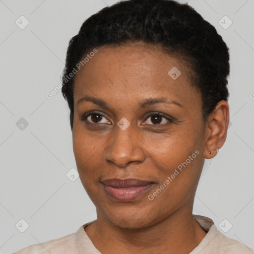 Joyful black young-adult female with short  black hair and brown eyes