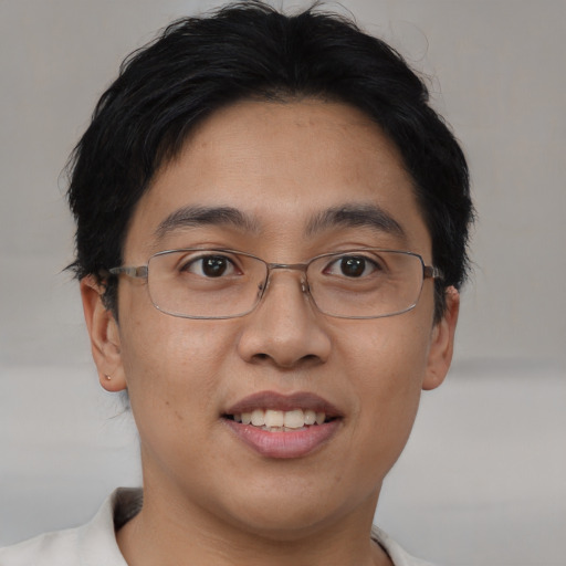 Joyful asian young-adult male with short  brown hair and brown eyes