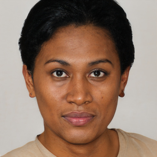 Joyful black young-adult female with short  black hair and brown eyes