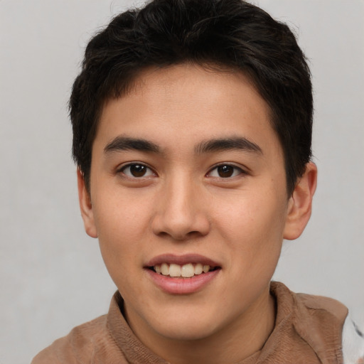 Joyful asian young-adult male with short  brown hair and brown eyes