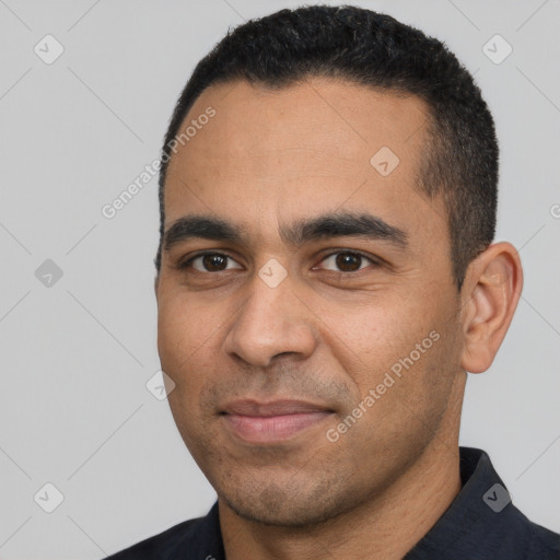 Joyful latino young-adult male with short  black hair and brown eyes