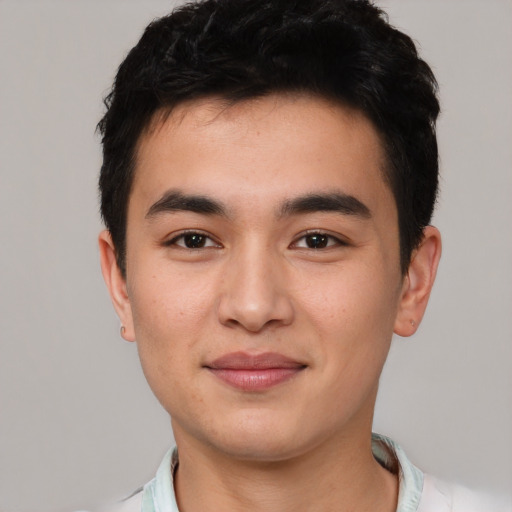 Joyful asian young-adult male with short  black hair and brown eyes