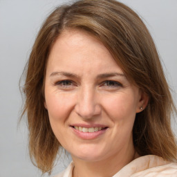 Joyful white adult female with medium  brown hair and brown eyes