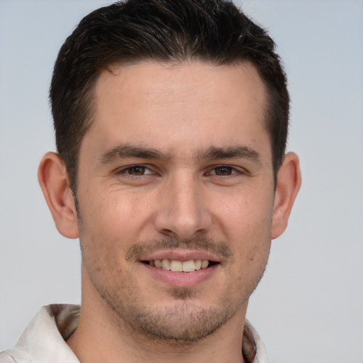 Joyful white young-adult male with short  brown hair and brown eyes