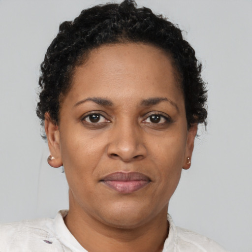 Joyful black adult female with short  brown hair and brown eyes