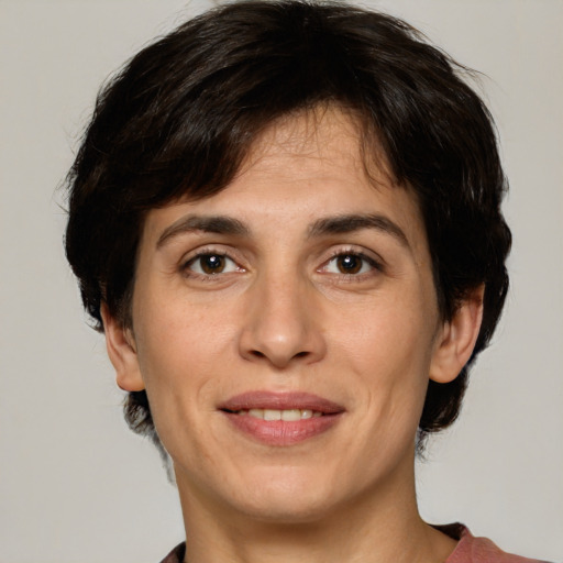 Joyful white adult female with medium  brown hair and green eyes