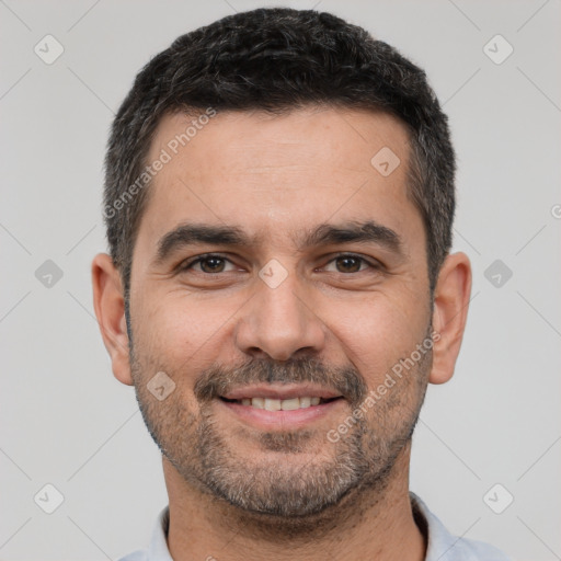 Joyful white adult male with short  black hair and brown eyes