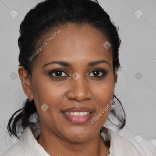 Joyful black adult female with medium  brown hair and brown eyes