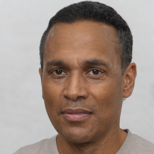 Joyful latino adult male with short  black hair and brown eyes