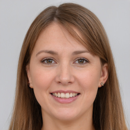 Joyful white young-adult female with long  brown hair and grey eyes