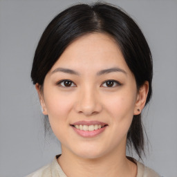 Joyful asian young-adult female with medium  brown hair and brown eyes