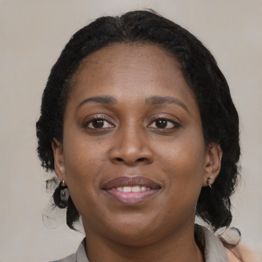 Joyful black young-adult female with medium  brown hair and brown eyes
