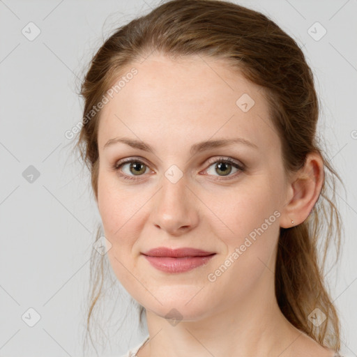 Joyful white young-adult female with medium  brown hair and green eyes