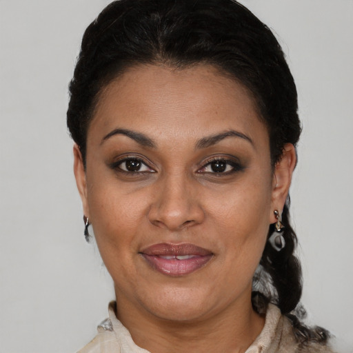 Joyful latino adult female with short  brown hair and brown eyes