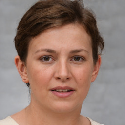 Joyful white young-adult female with short  brown hair and grey eyes