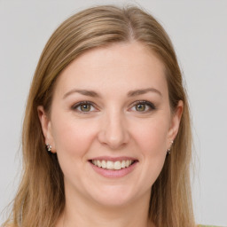 Joyful white young-adult female with long  brown hair and green eyes