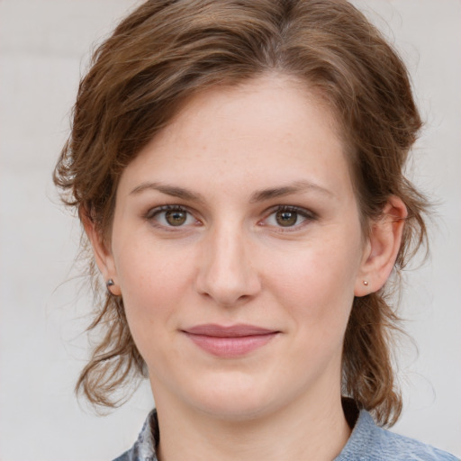 Joyful white young-adult female with medium  brown hair and blue eyes