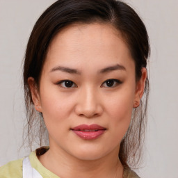 Joyful asian young-adult female with medium  brown hair and brown eyes