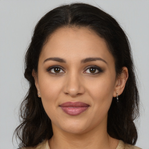 Joyful latino young-adult female with medium  brown hair and brown eyes