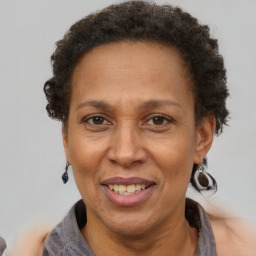 Joyful black adult female with short  brown hair and brown eyes