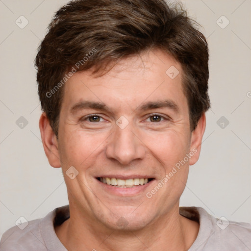 Joyful white adult male with short  brown hair and grey eyes