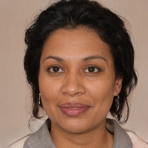 Joyful black adult female with medium  brown hair and brown eyes