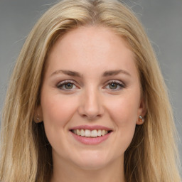 Joyful white young-adult female with long  brown hair and green eyes