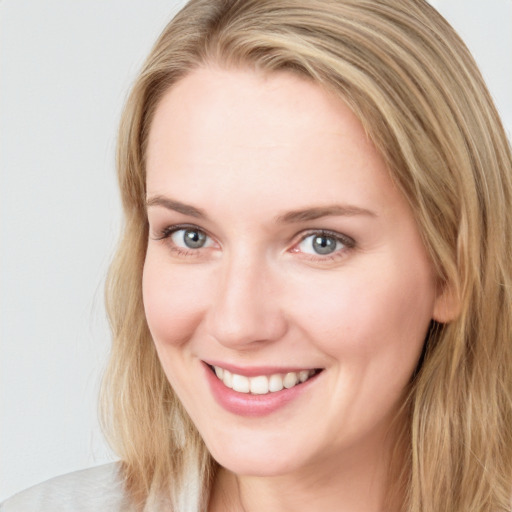 Joyful white young-adult female with long  brown hair and blue eyes