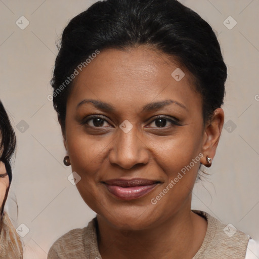 Joyful black adult female with medium  brown hair and brown eyes