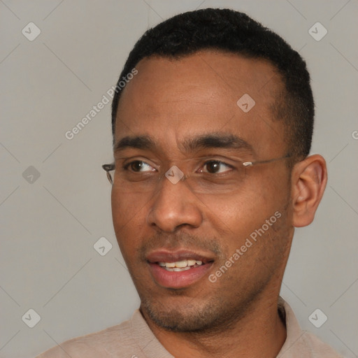 Joyful black young-adult male with short  black hair and brown eyes