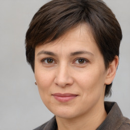 Joyful white adult female with medium  brown hair and brown eyes