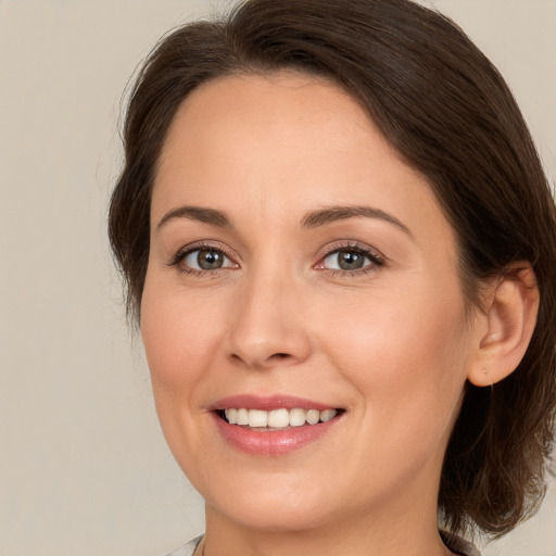 Joyful white young-adult female with medium  brown hair and brown eyes