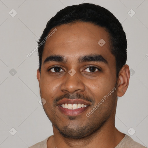 Joyful black young-adult male with short  black hair and brown eyes