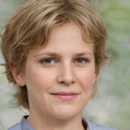 Joyful white young-adult female with medium  brown hair and blue eyes