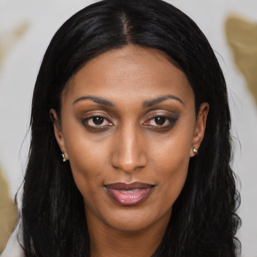 Joyful black young-adult female with long  brown hair and brown eyes
