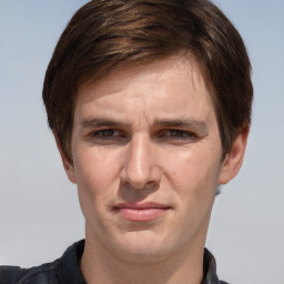 Joyful white adult male with short  brown hair and grey eyes