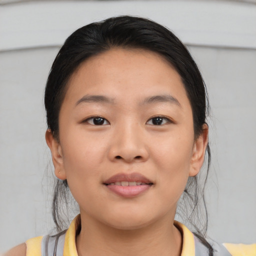 Joyful asian young-adult female with medium  brown hair and brown eyes