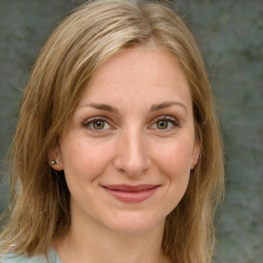 Joyful white young-adult female with medium  brown hair and green eyes