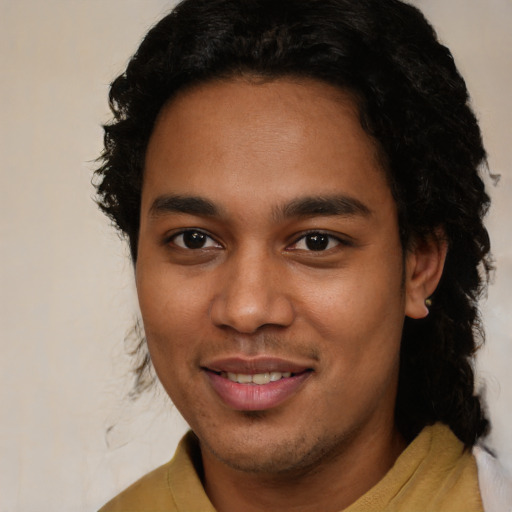 Joyful latino young-adult male with short  brown hair and brown eyes